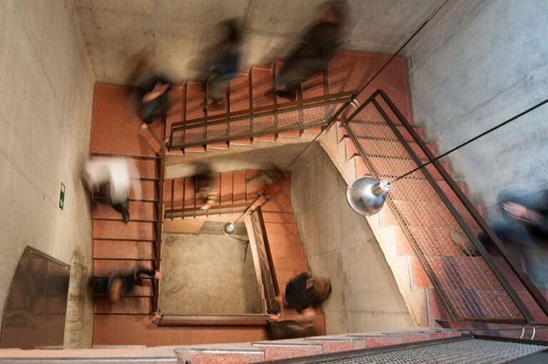 A group walking down several flights of stairs.
