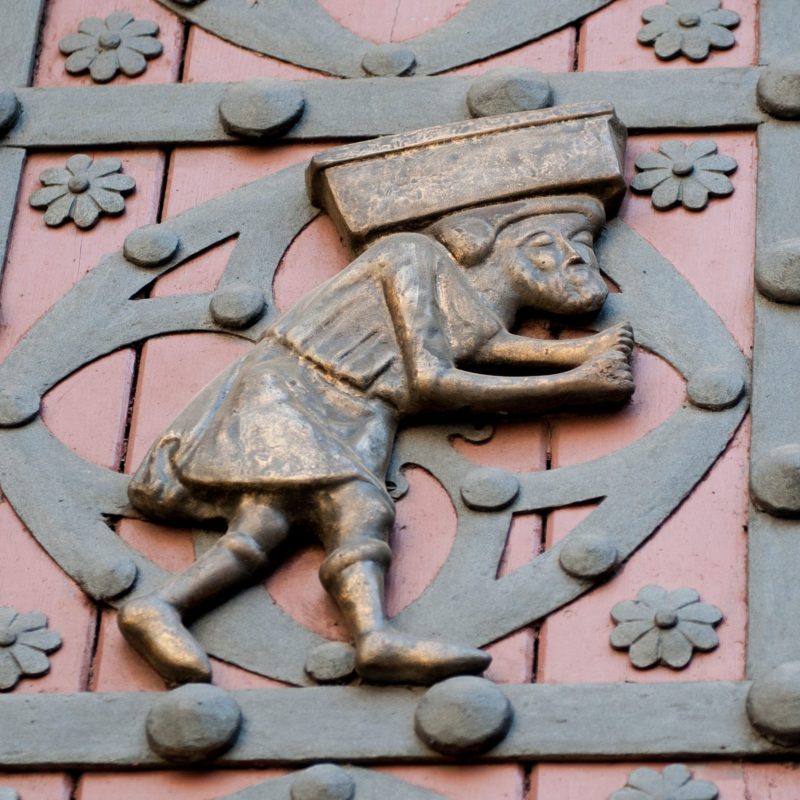 Detailed of a bronze dock worker on the door of the Santa Maria del Mar Church.