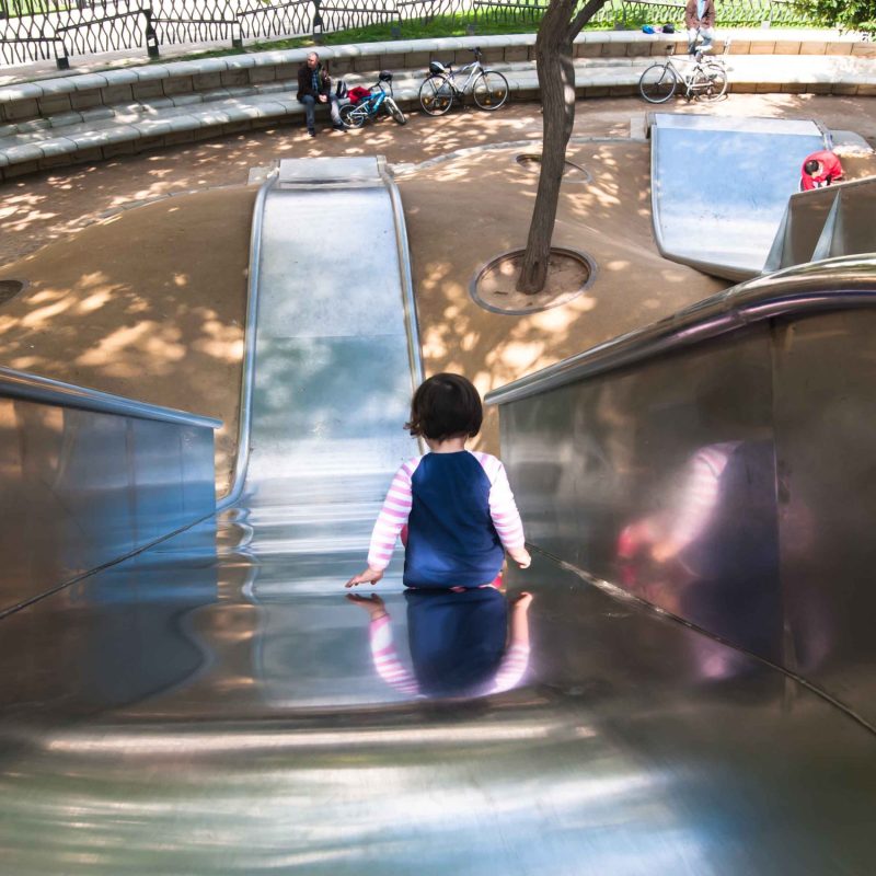 A little girl on the large slide at Diagonal mar park.