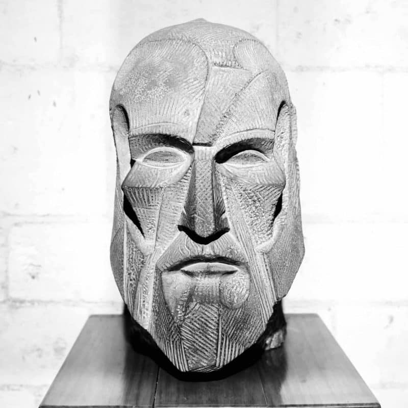 A bust of Gaudi in stone.