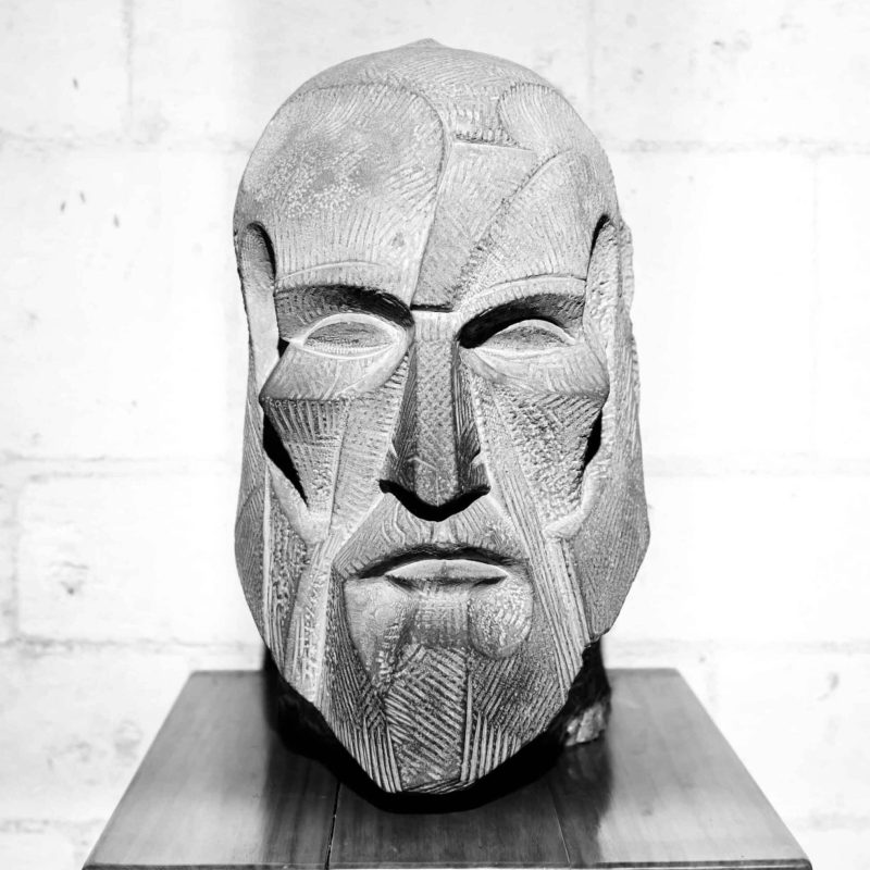 A bust of Gaudi in stone.