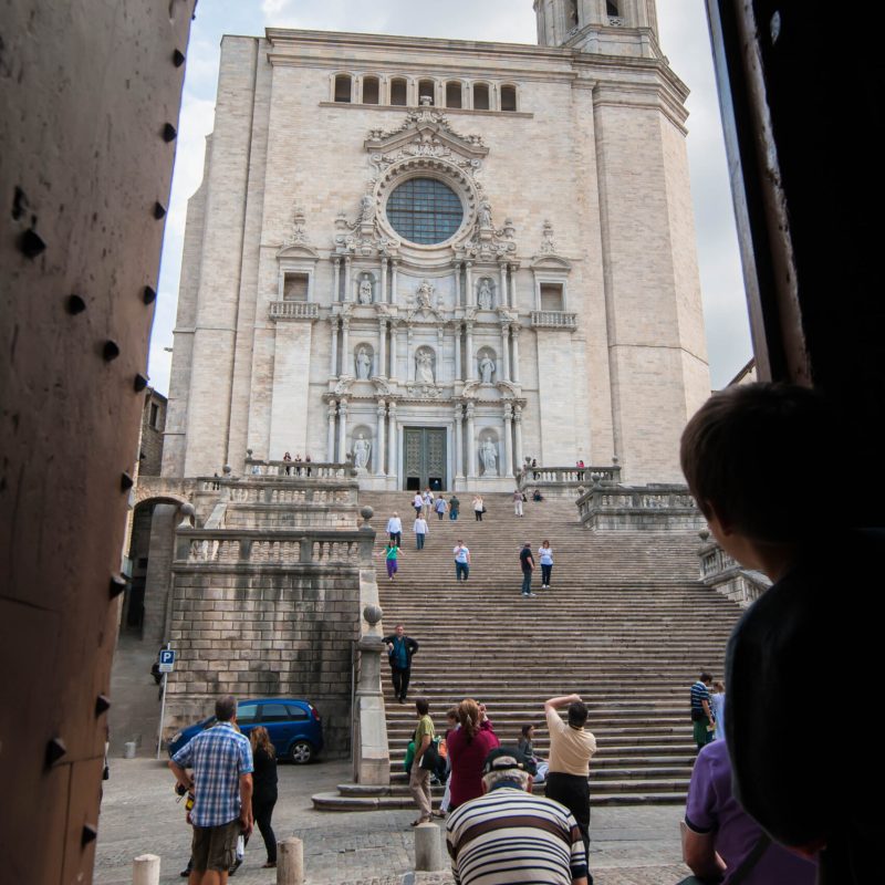 A child peeps out towards the Catheral of Girona.