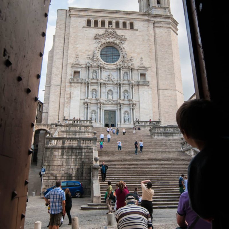 A child peeps out towards the Catheral of Girona.