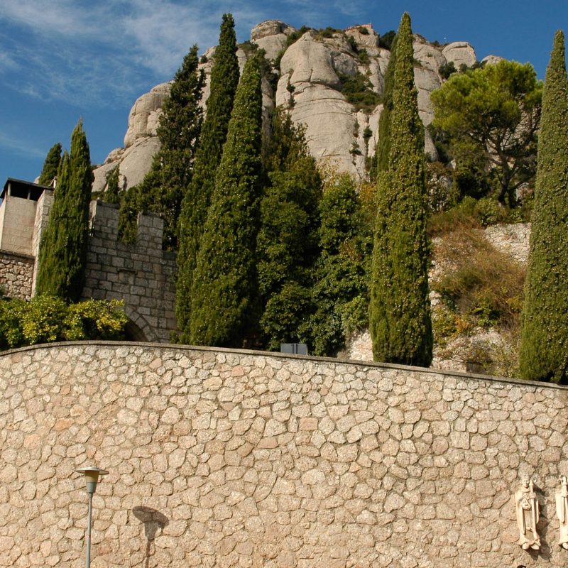 The buildings are built at the base of the formations.