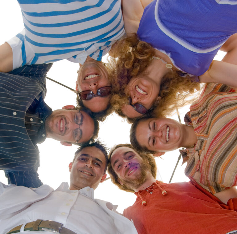 A group of friends posing for a picture at this BBQ reception event.