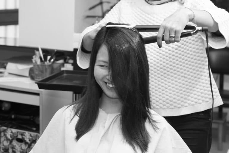 Working on her hair style at the hair salon for her couples photo shoot.