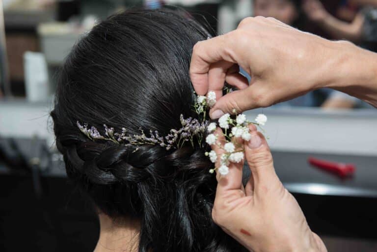 Fitting her flowers in her hair at the beauty salon for her couples photo shoot.