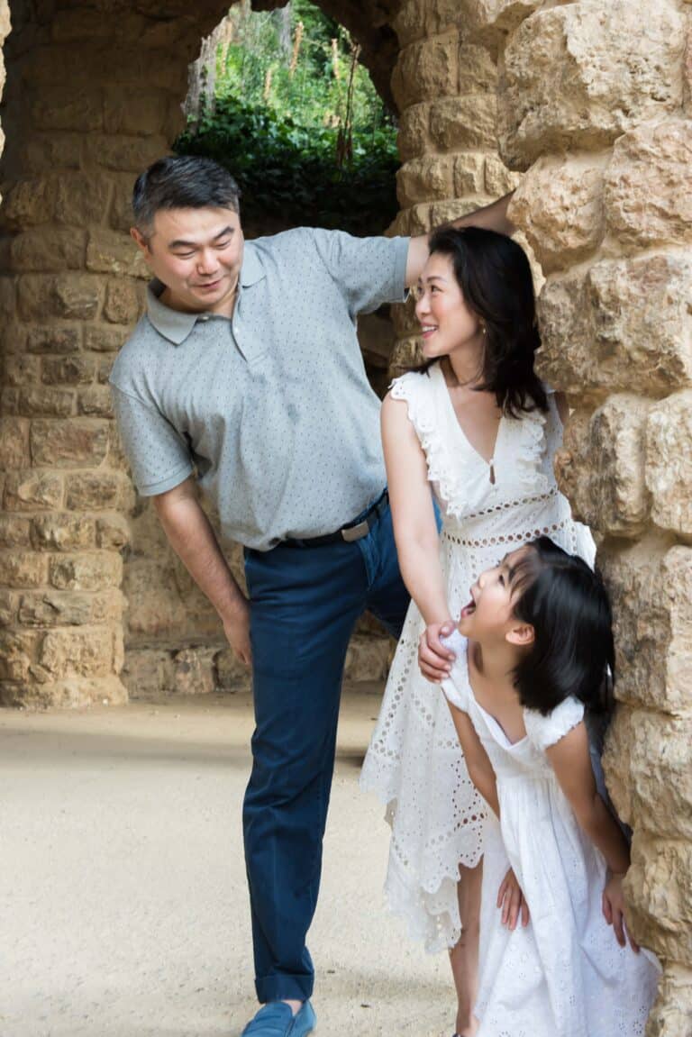 A family being playful at Park Guell.