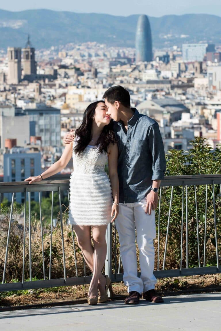 A couple sharing a kiss on montjuic hill on their engagement photography session in Barcelona.