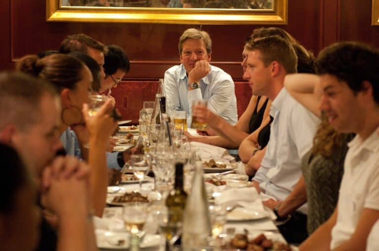 The boss at the head of the table during his company retreat.