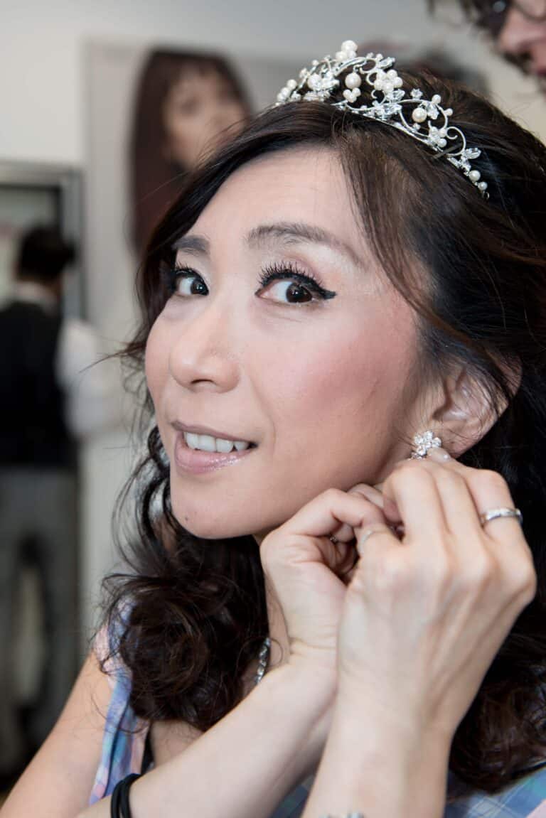 Putting on her earrings at the stylist for her engagement photo session.