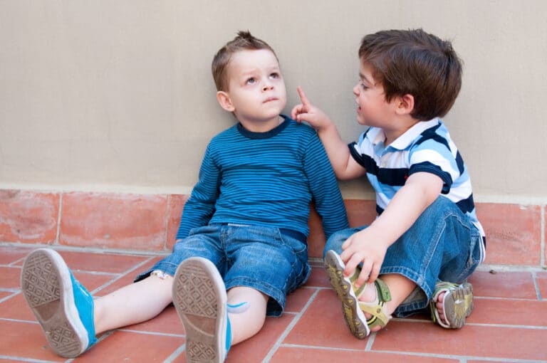 Two 3 year olds having a discussion at this birthday party.