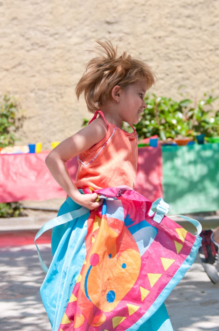 A child having fun in the potato sack race at this kids birthday party.
