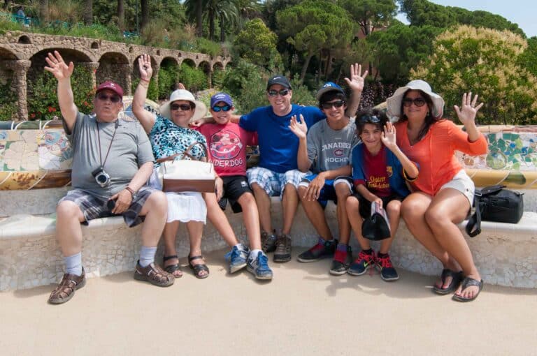 A family sitting on the Park Güell bench on one of their multi-day tours.