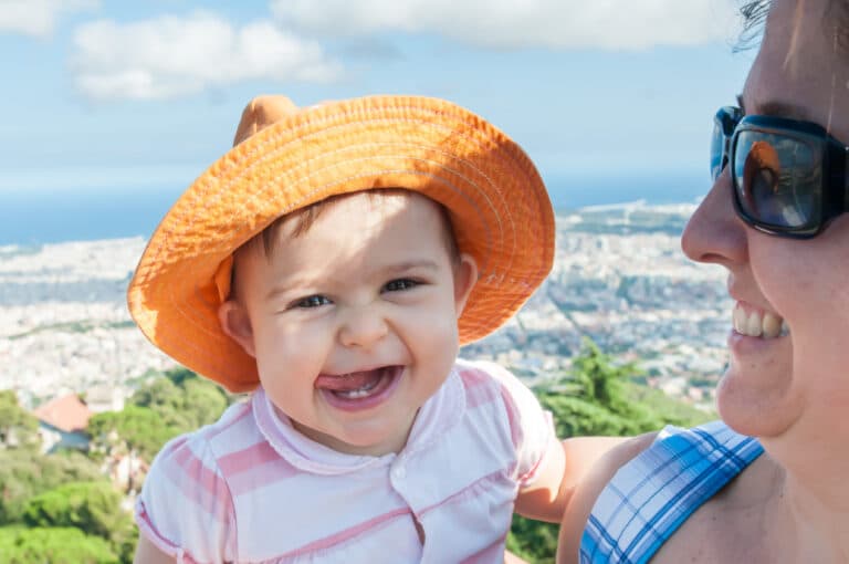 A happy baby girl with mom at Tibidabo, Barcelona.