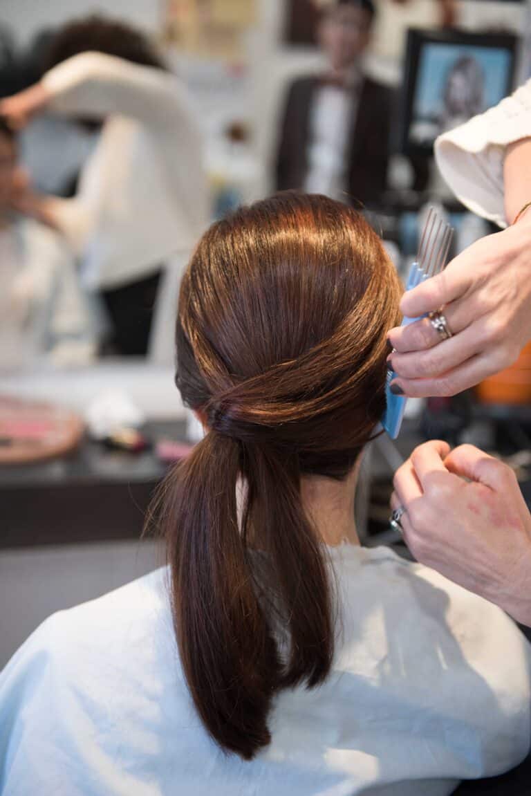 Getting her hair styled before her couples pre wedding session.