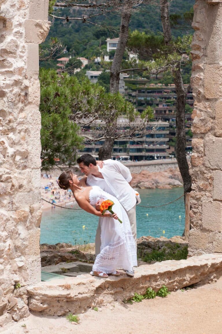 A shot of a couple framed against the remains of an old roman church on the Costa Brava during their photo shoot.